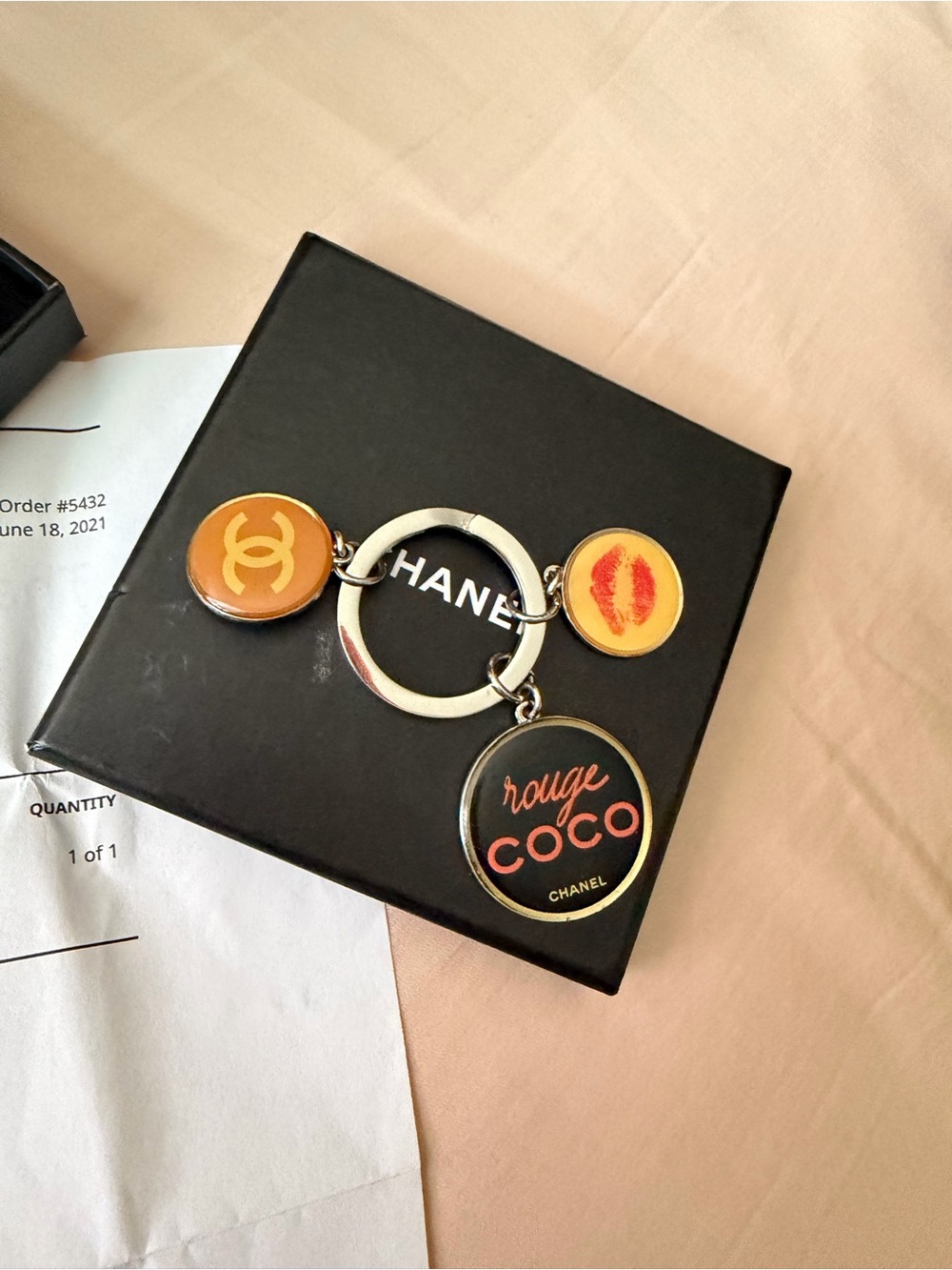 Authentic CHANEL Rouge Coco Logo Charm Keyring in Black and Gold